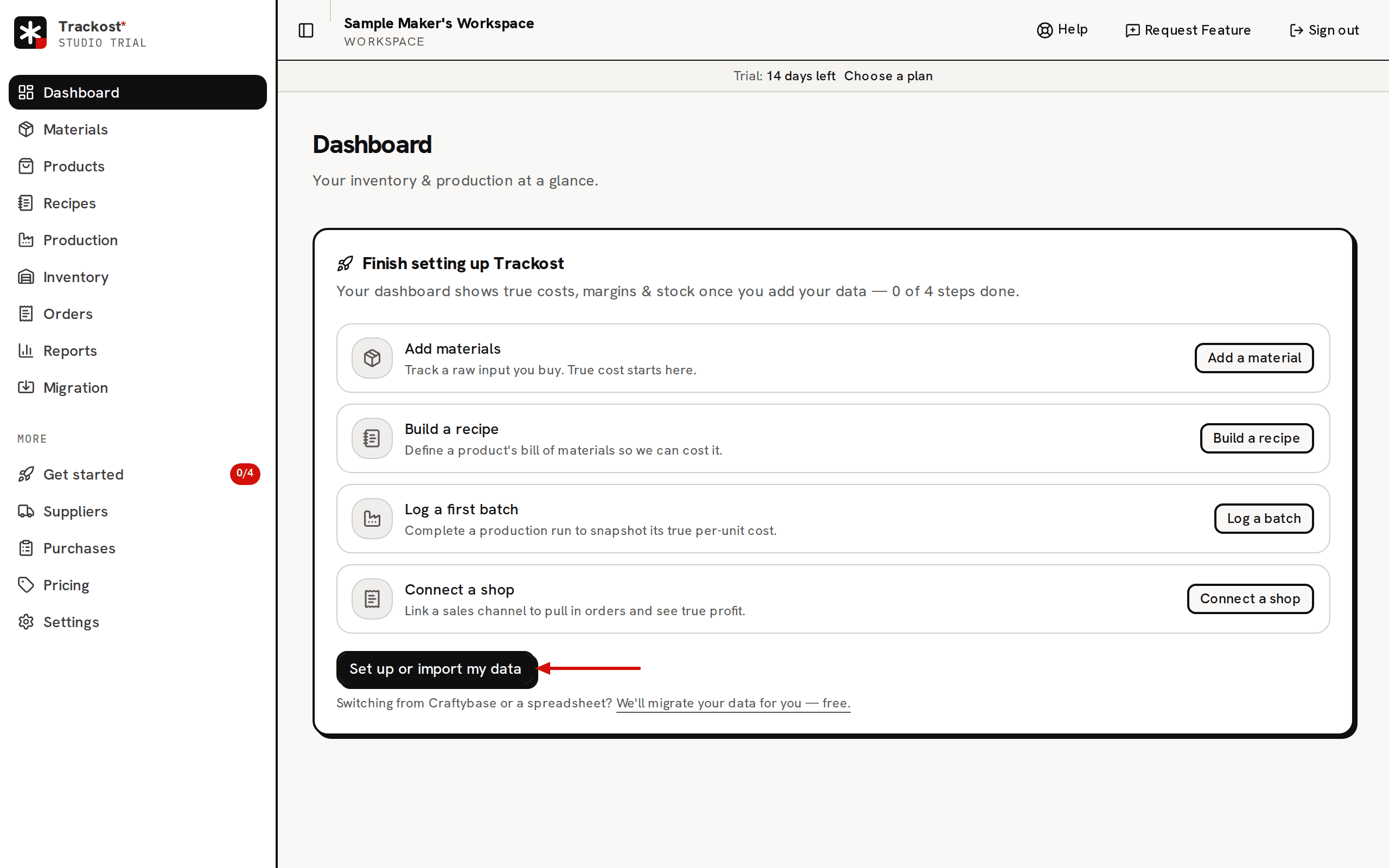 The Dashboard of a new, empty workspace: the Finish setting up Trackost board with its four setup rows, and an arrow pointing at the Set up or import my data button